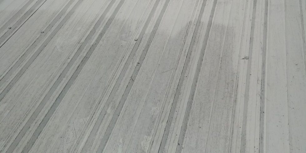 Roof surface showing cleaned metal panels after pressure washing by ACME Pressure Washing, highlighting effective roof cleaning results.