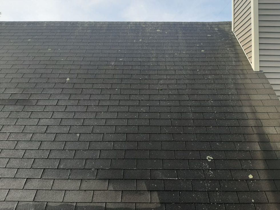 Roof showing dirt and algae buildup, highlighting the need for pressure washing services by ACME Pressure Washing.